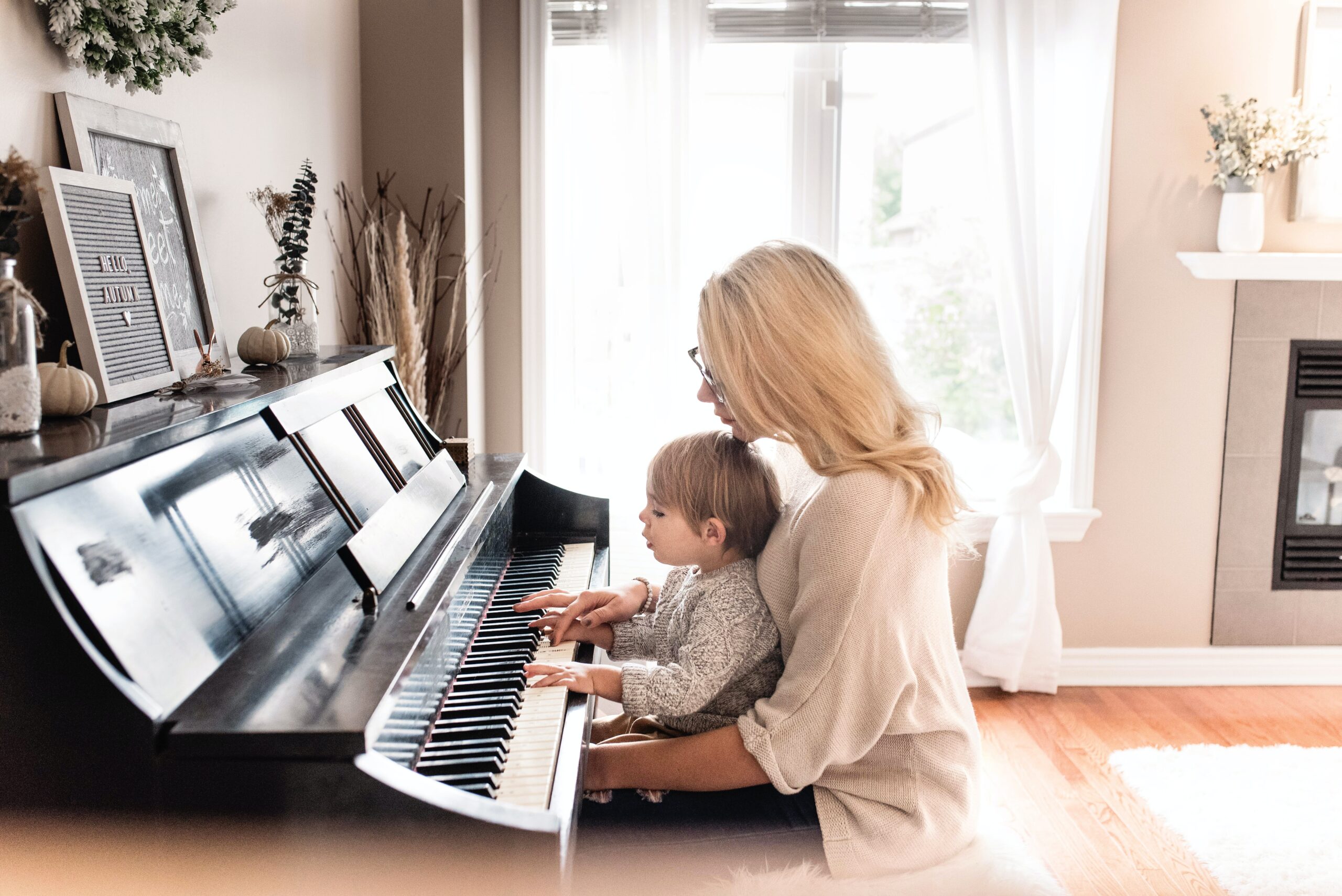 Mother placing piano with her child
